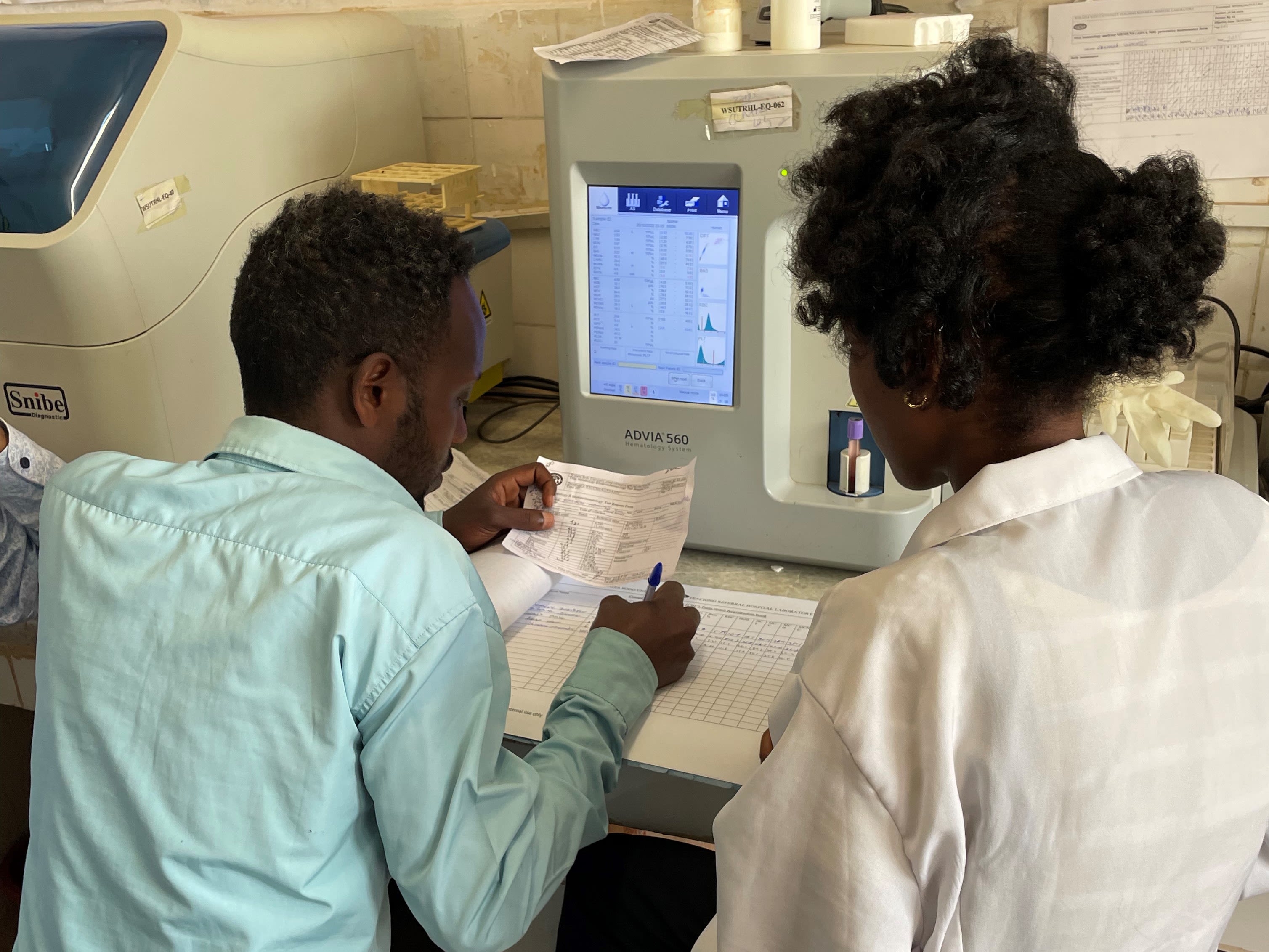 Man and woman look at computer screen