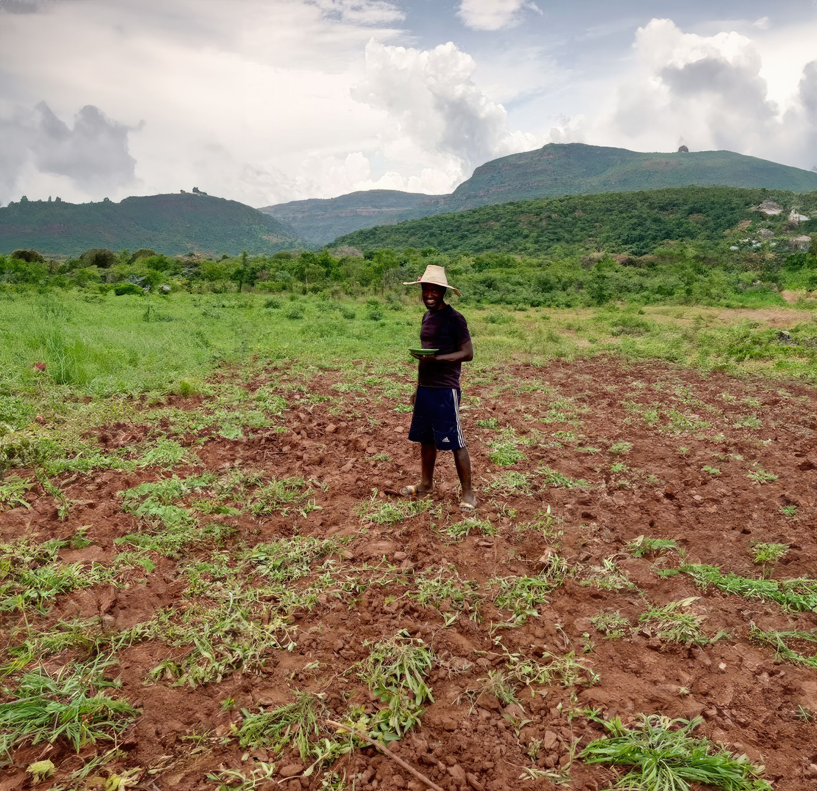 Smiling man stands in field