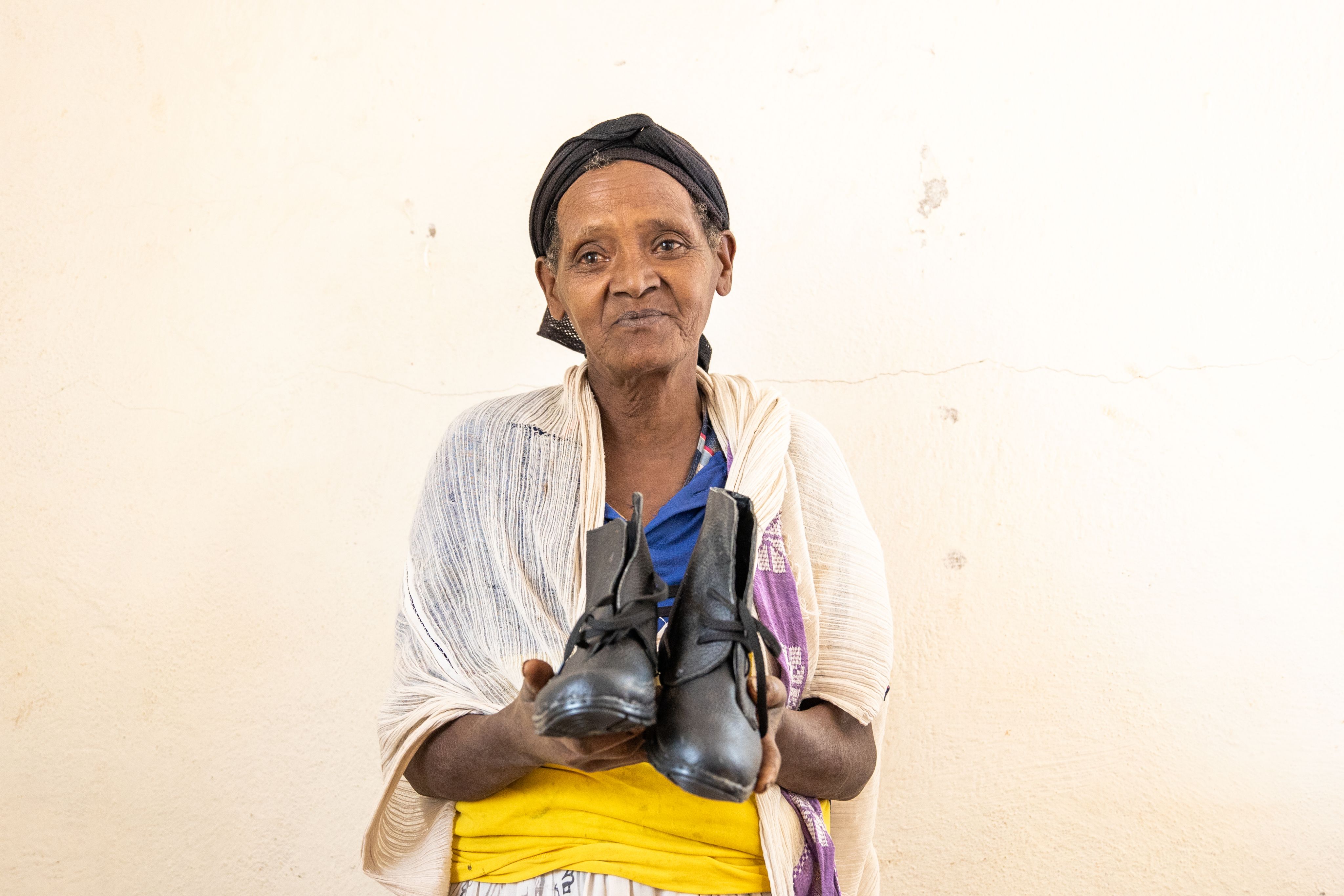 Woman holds pair of boots