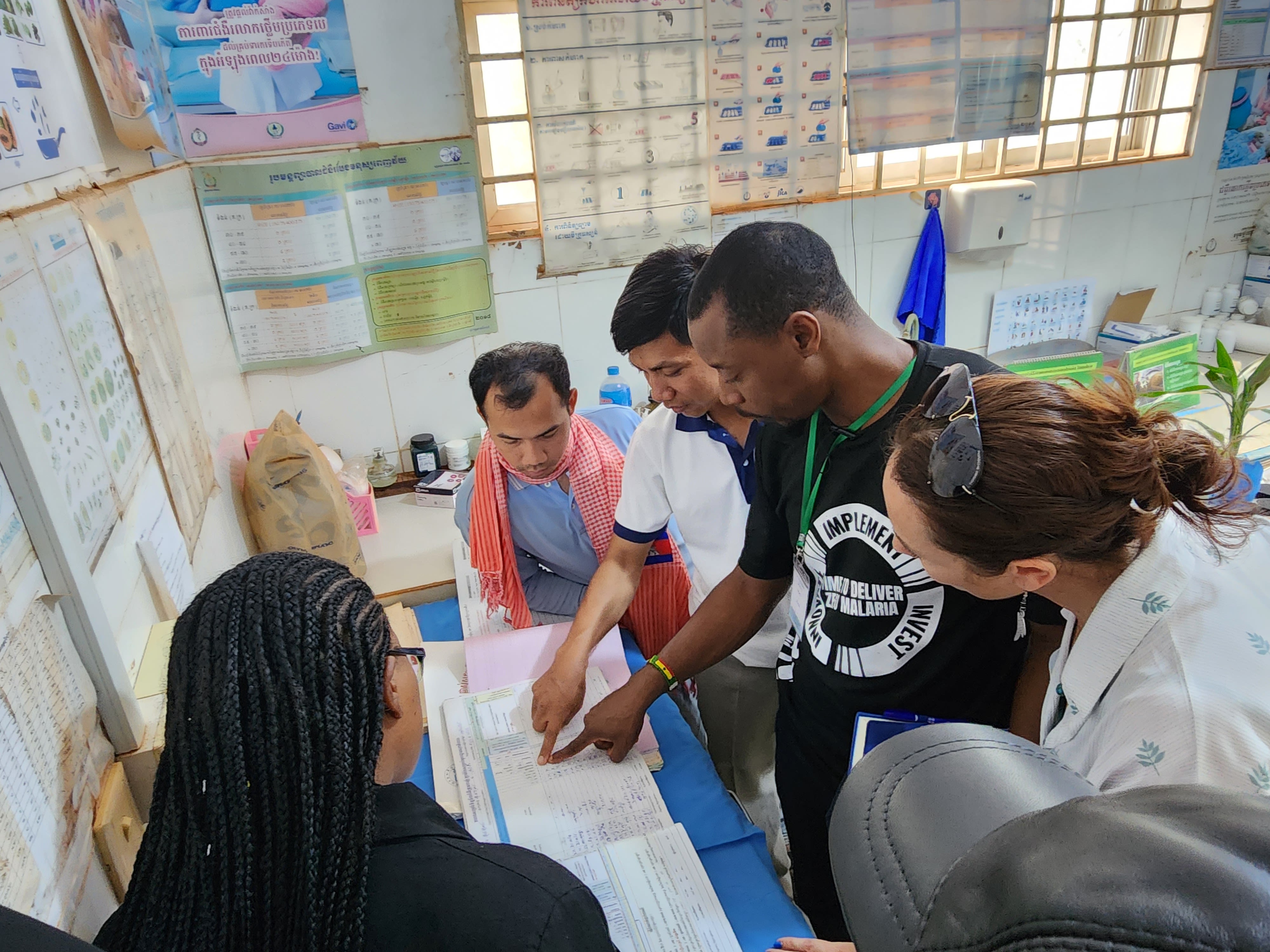 Group of people look at data sheets together